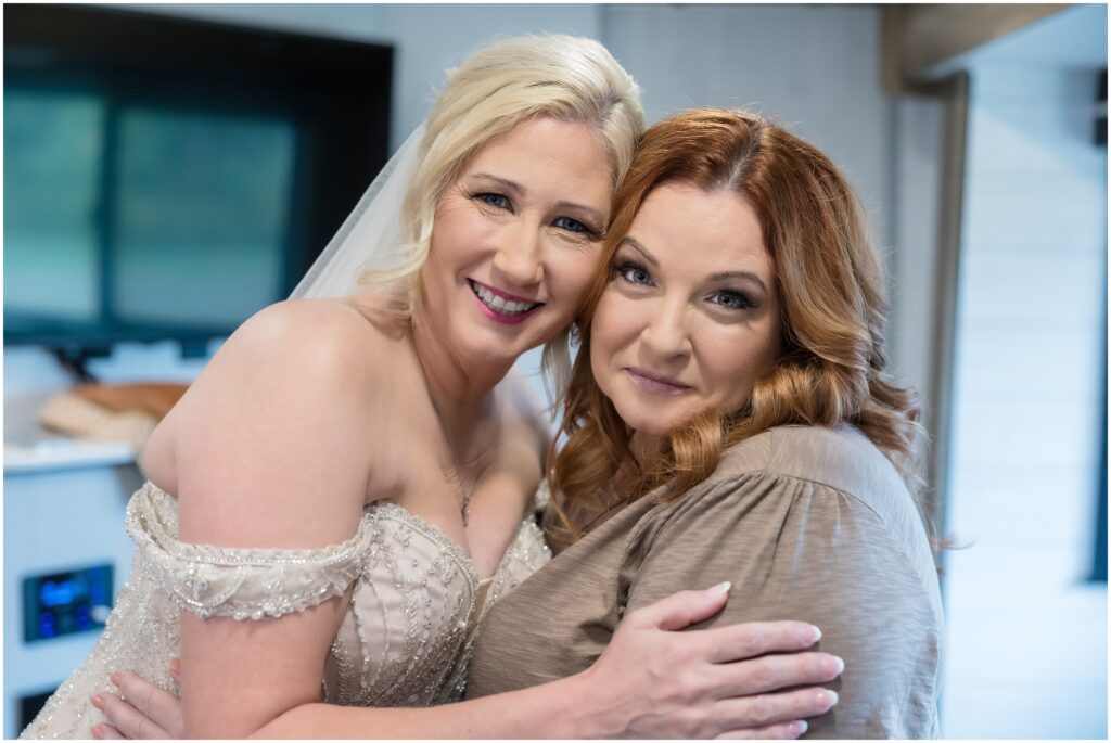 Image of bride with Maid of honor both looking at camera