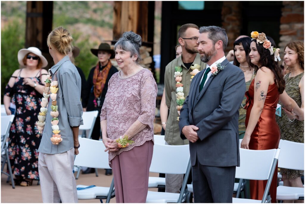 Wedding guests watching an outdoor wedding ceremony
